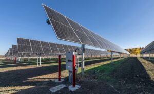 Solar farm on tall structures under a blue sky